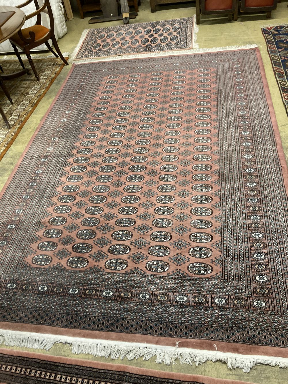 A Bokhara red ground small carpet, a pink ground runner and two other rugs (4), largest 320 x 222cm